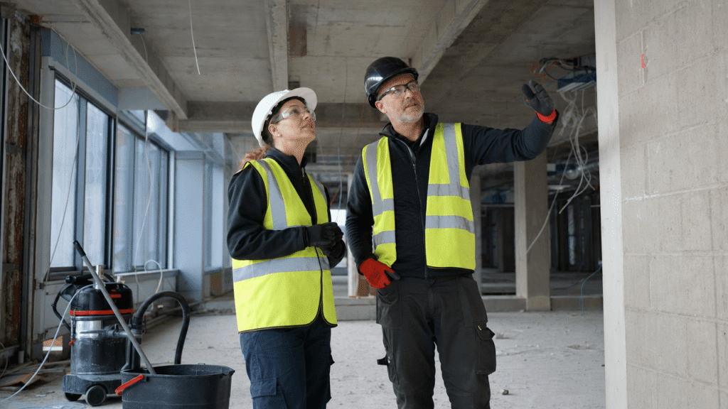 Cleaning personnel assessing conditions before work on a construction site