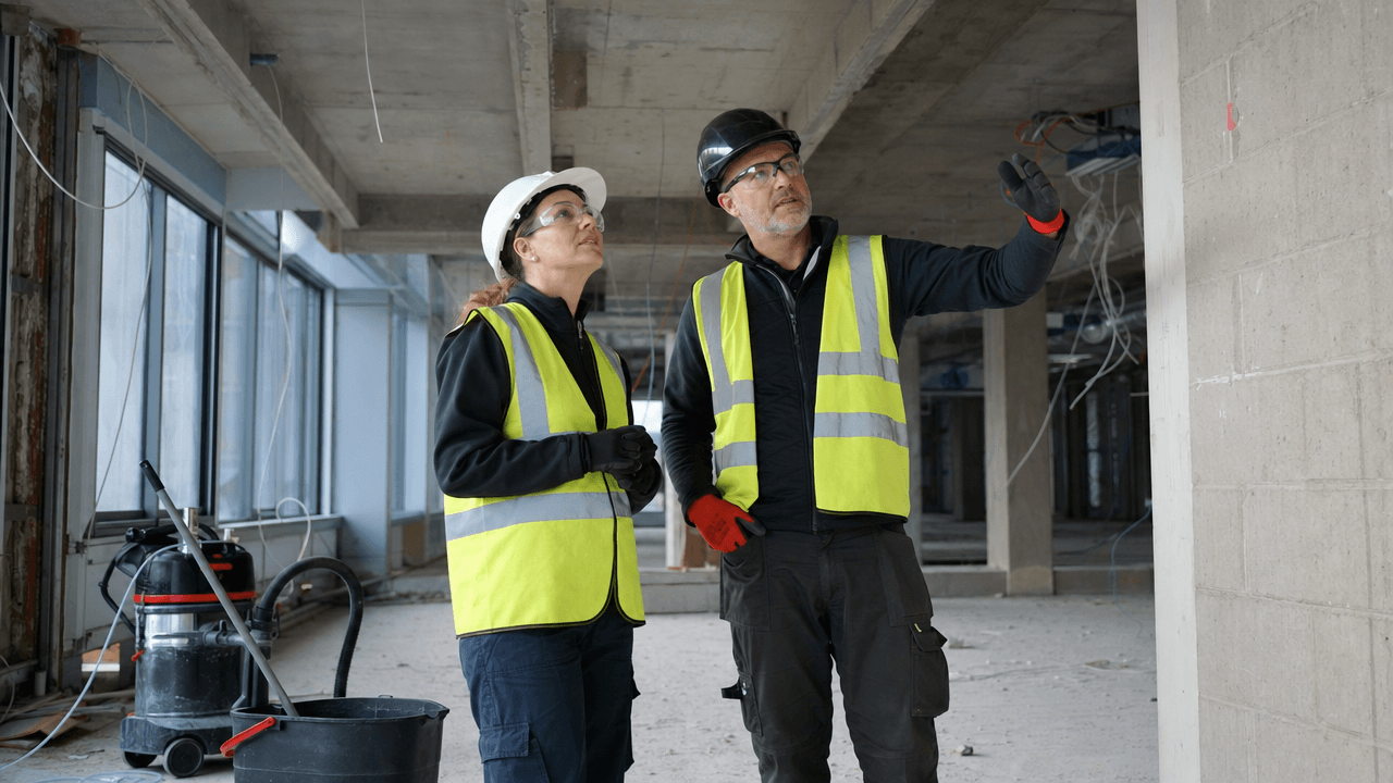 Cleaning personnel assessing conditions before work on a construction site