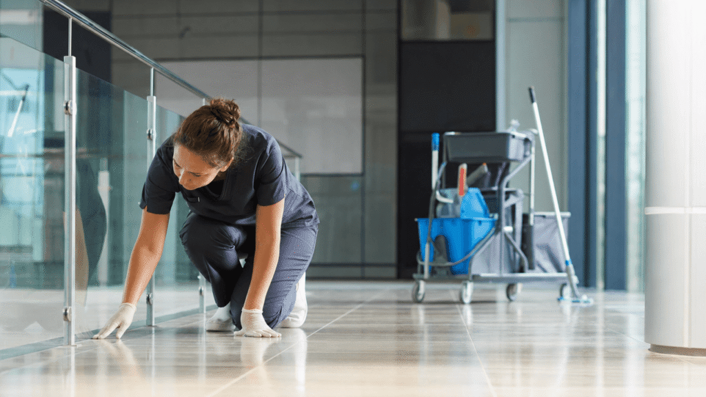 Professional cleaner inspecting a completed cleaning area in a commercial property.